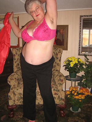 Girdlegoddess is sexy and relaxed at home in her red satin shirt and pink Hi heels. Cum and see as she takes it off sh